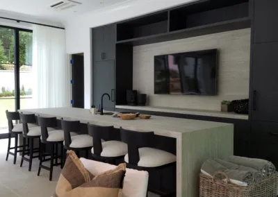 A room with a bar and a television.
