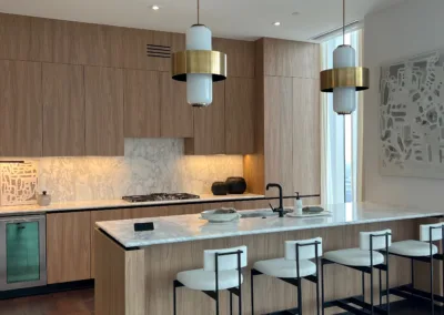 A kitchen with a bar and stools.